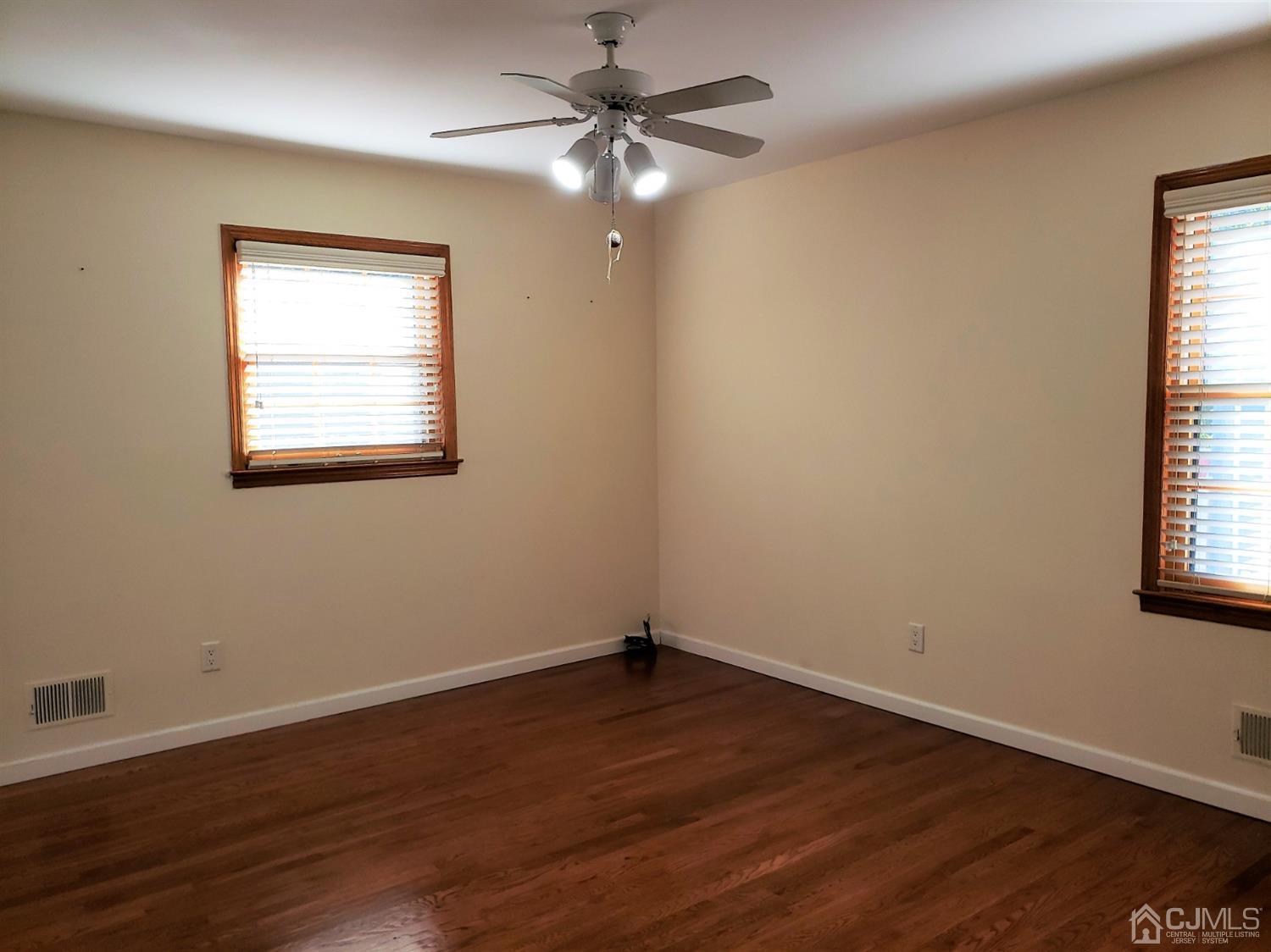 24 Hillsdale Road Edison, NJ 08820 - Photo 15 of 41 a view of an empty room with wooden floor and a window