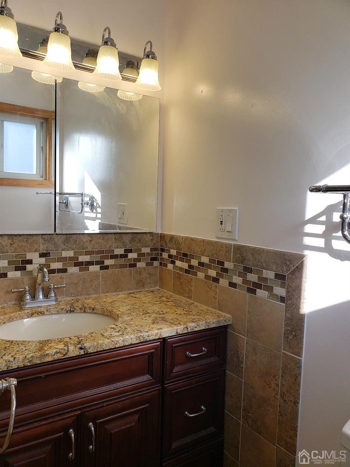 24 Hillsdale Road Edison, NJ 08820 - Photo 18 of 41 a bathroom with a granite countertop sink a mirror and shower