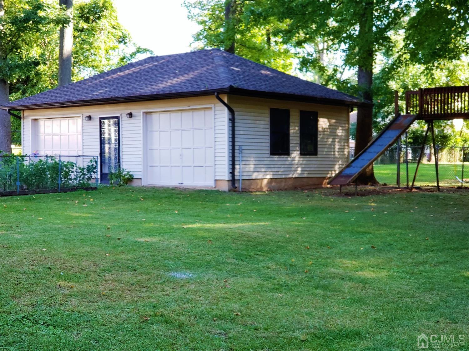 24 Hillsdale Road Edison, NJ 08820 - Photo 23 of 41 a view of a house with a backyard and a slide