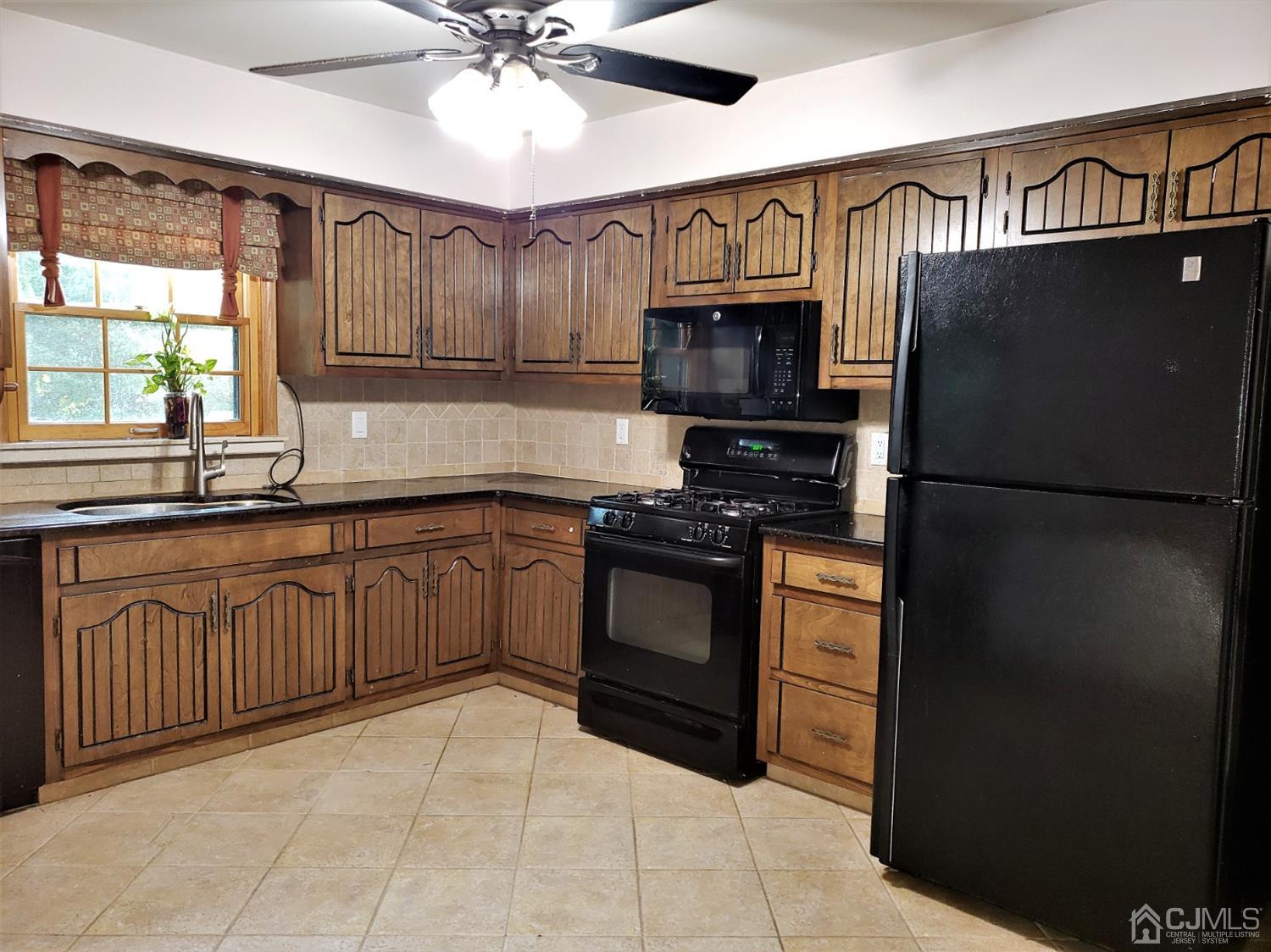 24 Hillsdale Road Edison, NJ 08820 - Photo 4 of 41 a kitchen with granite countertop a refrigerator stove top oven and sink