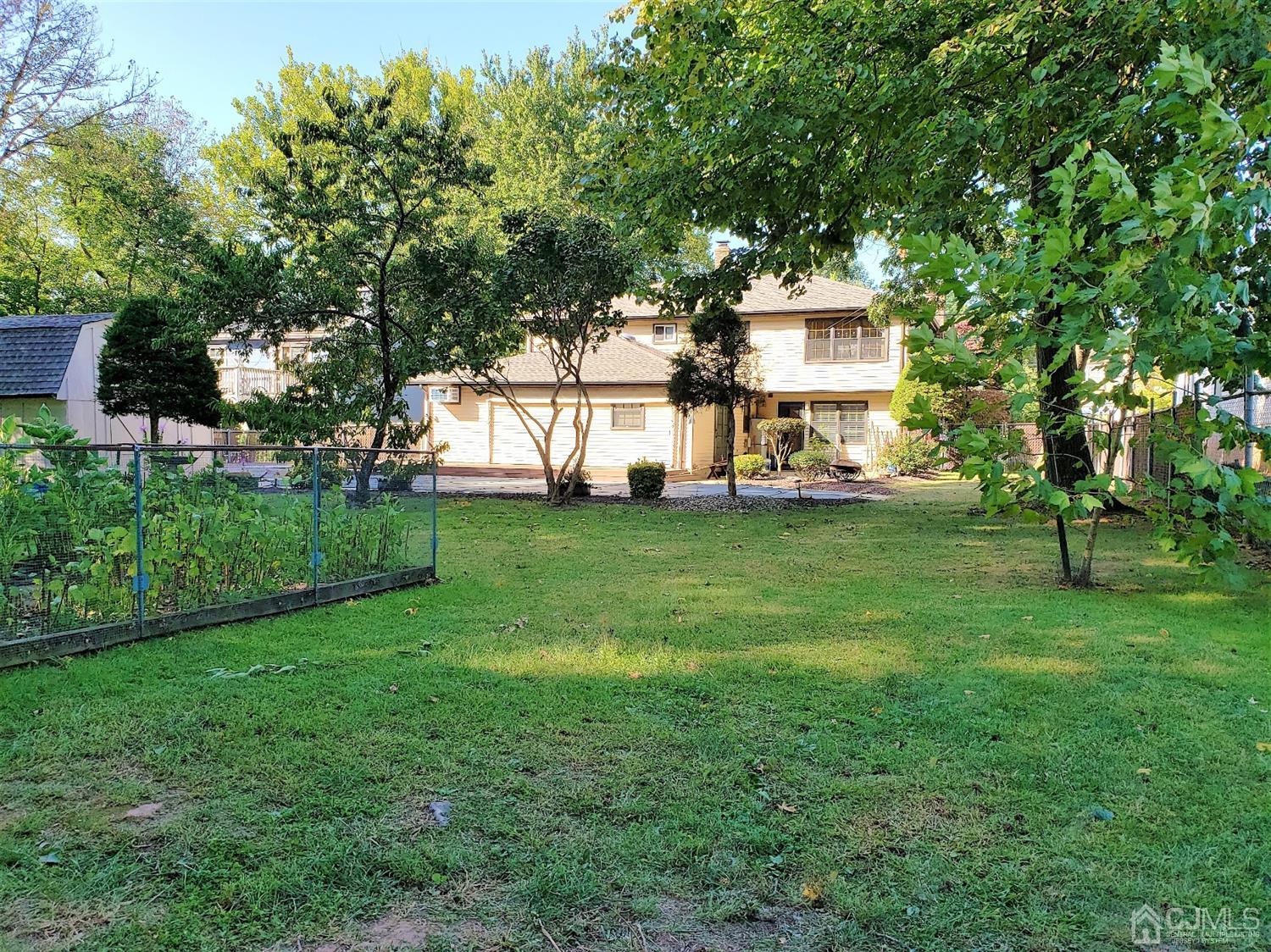 24 Hillsdale Road Edison, NJ 08820 - Photo 31 of 41 a front view of a house with a yard and trees