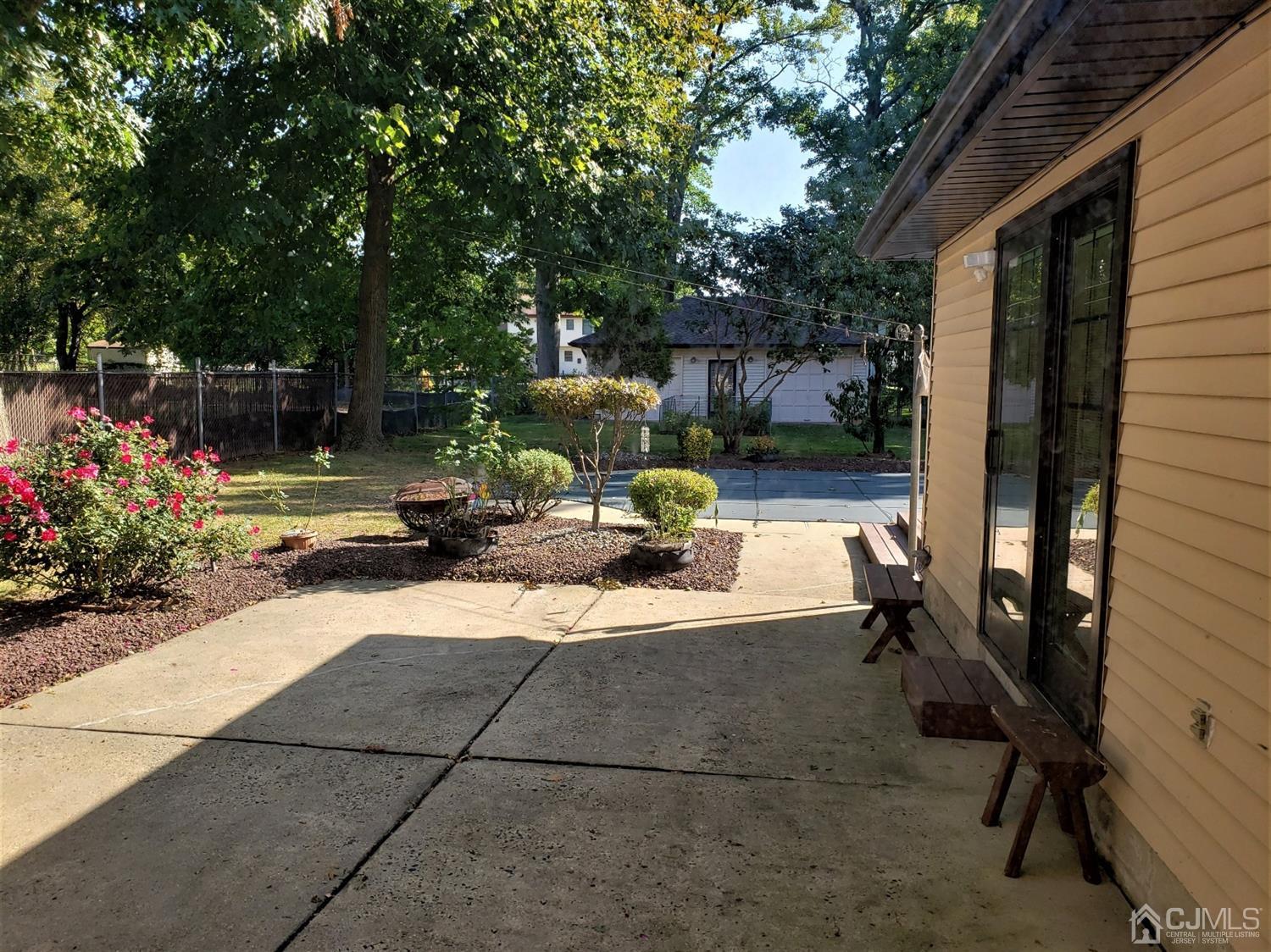 24 Hillsdale Road Edison, NJ 08820 - Photo 35 of 41 a view of a patio with table and chairs potted plants with large tree