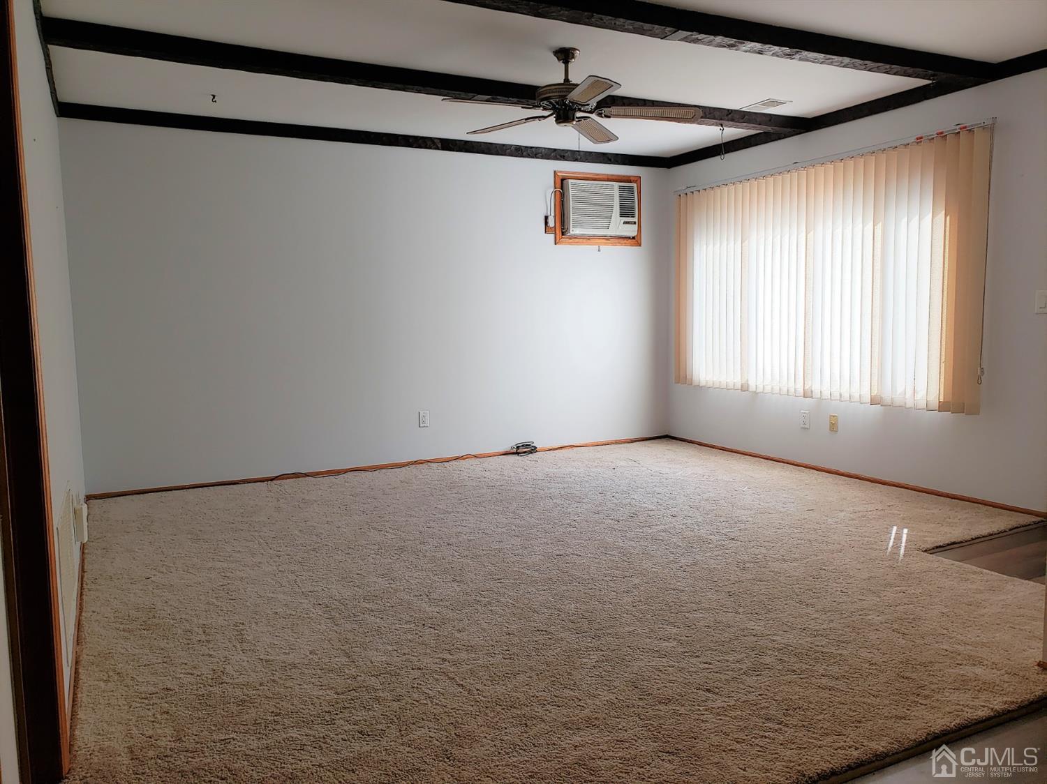 24 Hillsdale Road Edison, NJ 08820 - Photo 38 of 41 a view of a big room with windows and chandelier fan