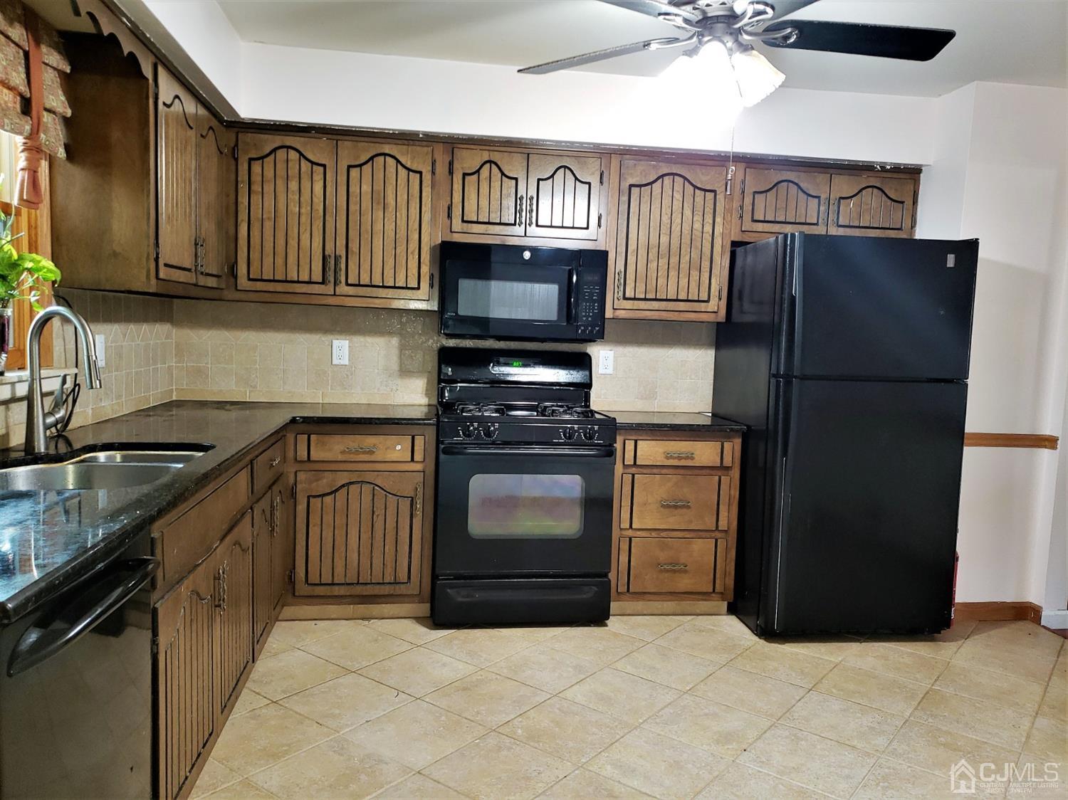 24 Hillsdale Road Edison, NJ 08820 - Photo 5 of 41 a kitchen with granite countertop a refrigerator stove and sink