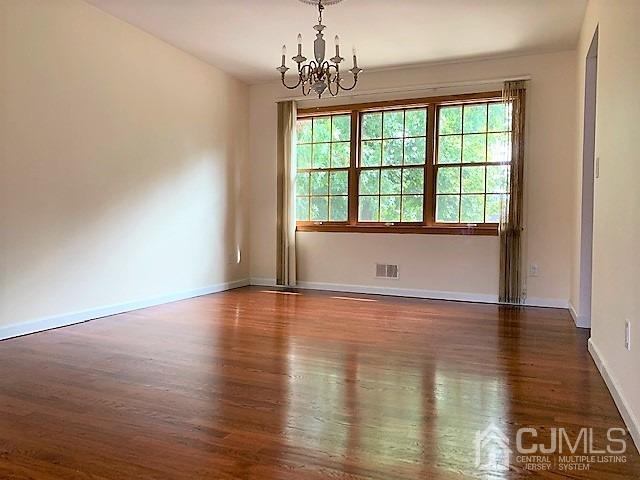 24 Hillsdale Road Edison, NJ 08820 - Photo 8 of 41 a view of an empty room with wooden floor and a window