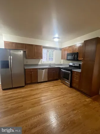 a large kitchen with cabinets and stainless steel appliances