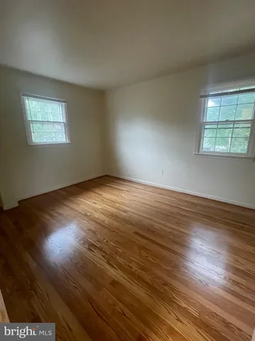 a view of an empty room and wooden floor
