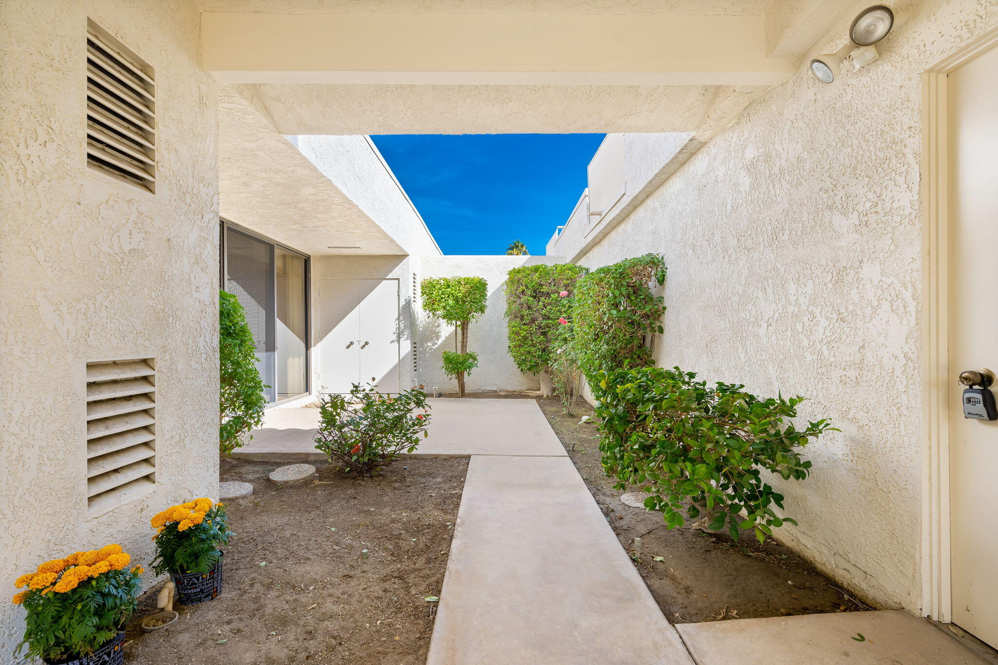 7 Tulane Court Rancho Mirage, CA 92270 - Photo 13 of 66 a view of front door of house with potted plant