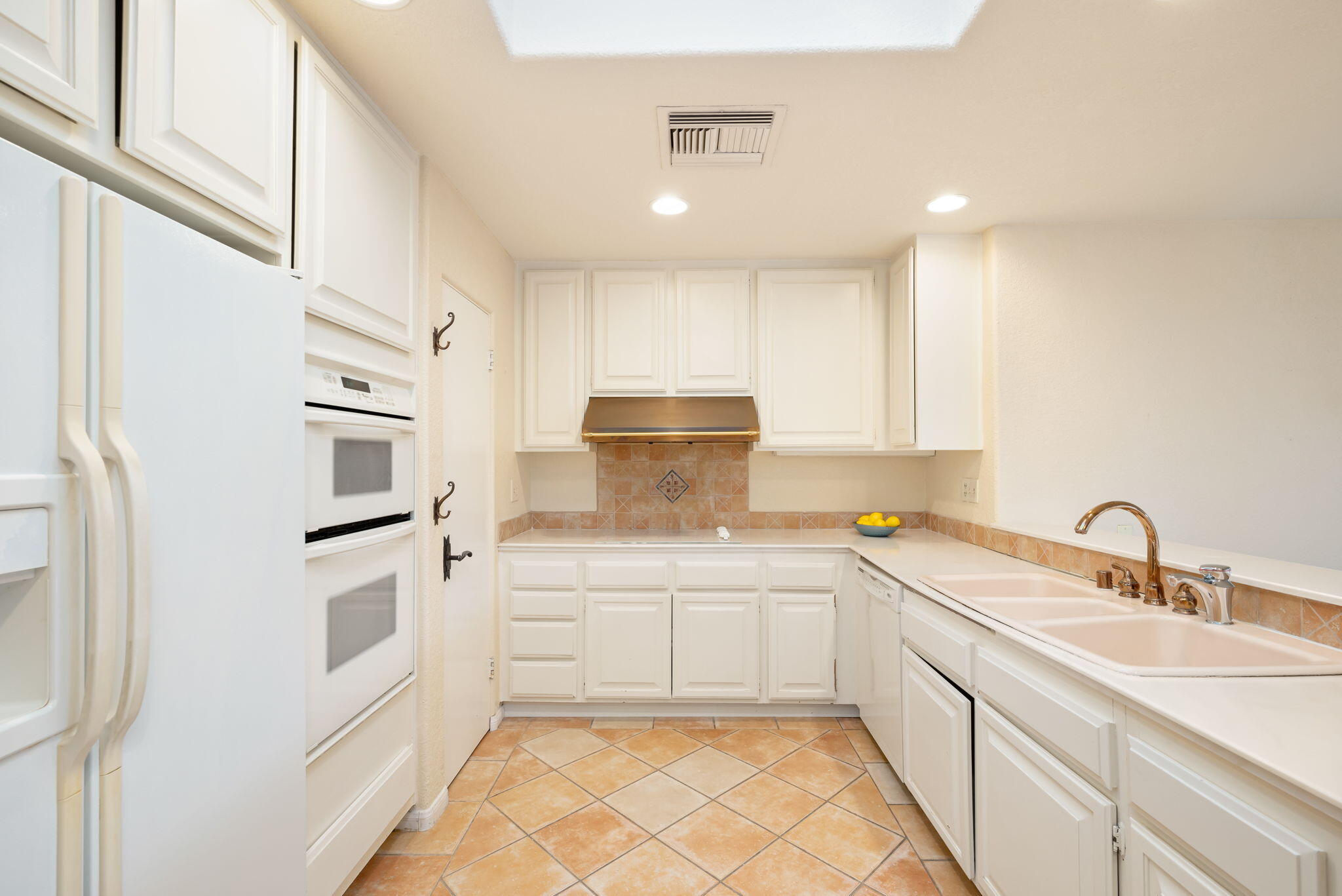 7 Tulane Court Rancho Mirage, CA 92270 - Photo 28 of 66 a kitchen with a sink stainless steel appliances and cabinets