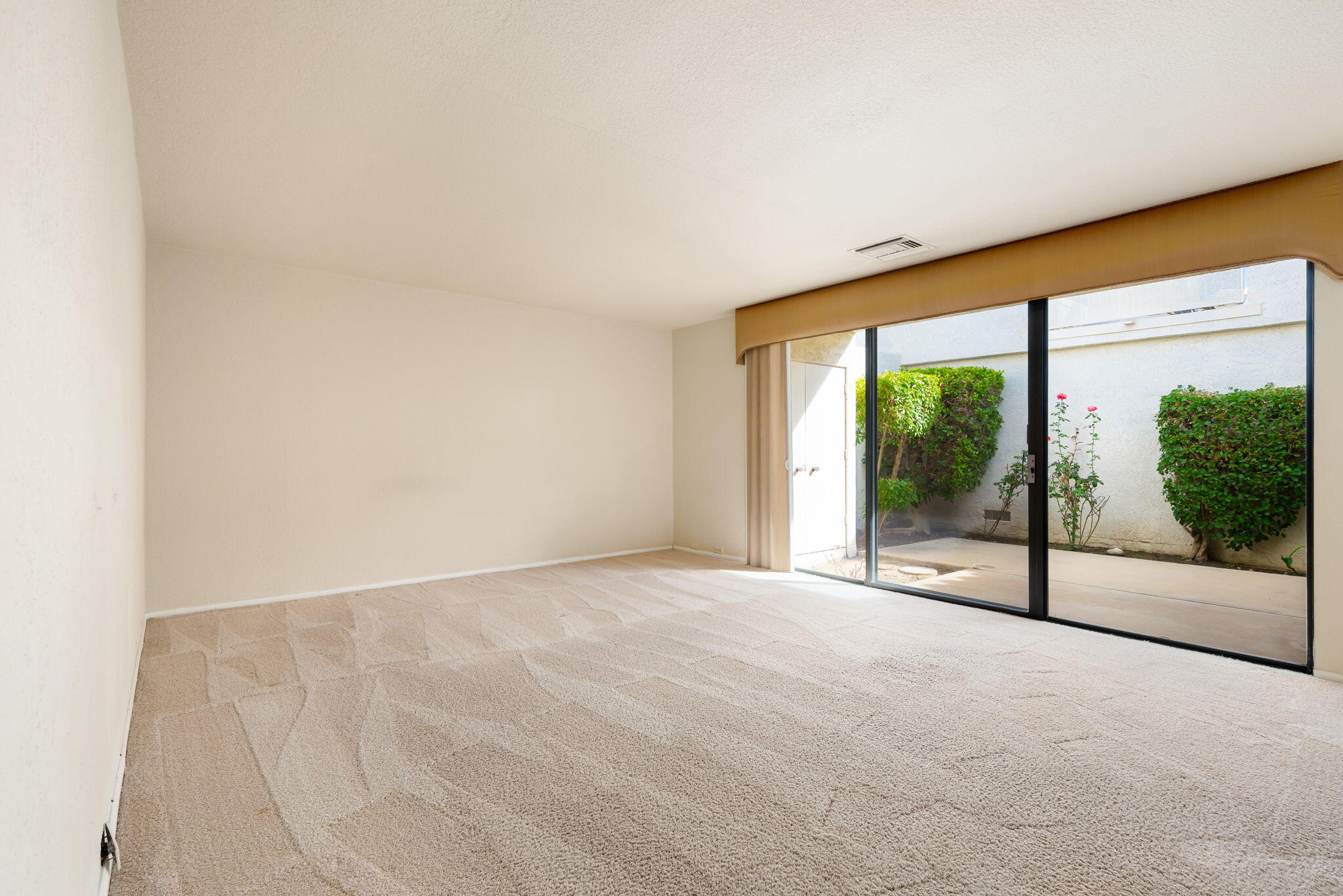 7 Tulane Court Rancho Mirage, CA 92270 - Photo 41 of 66 a view of an empty room with wooden floor and a window