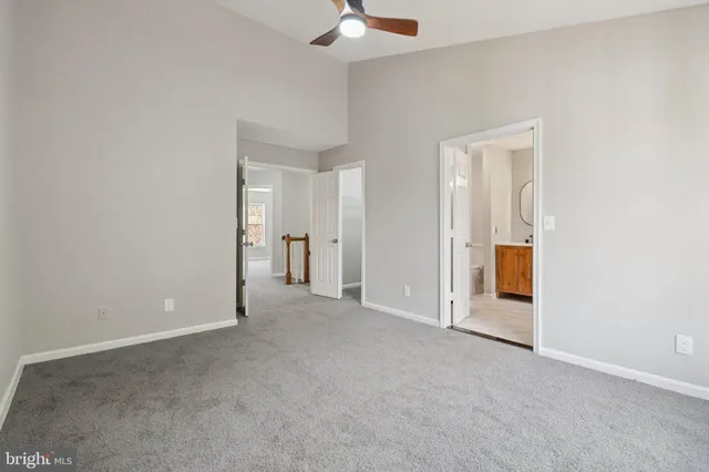 an empty room with chandelier fan