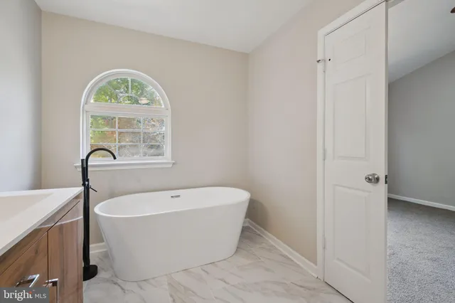 a white bath tub sitting next to a window