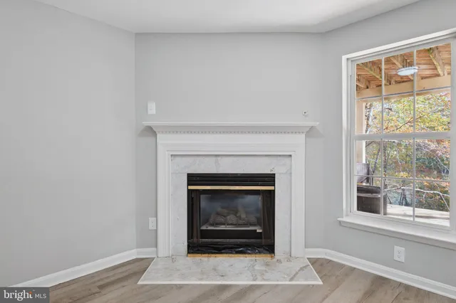 a living room with a fireplace and a window