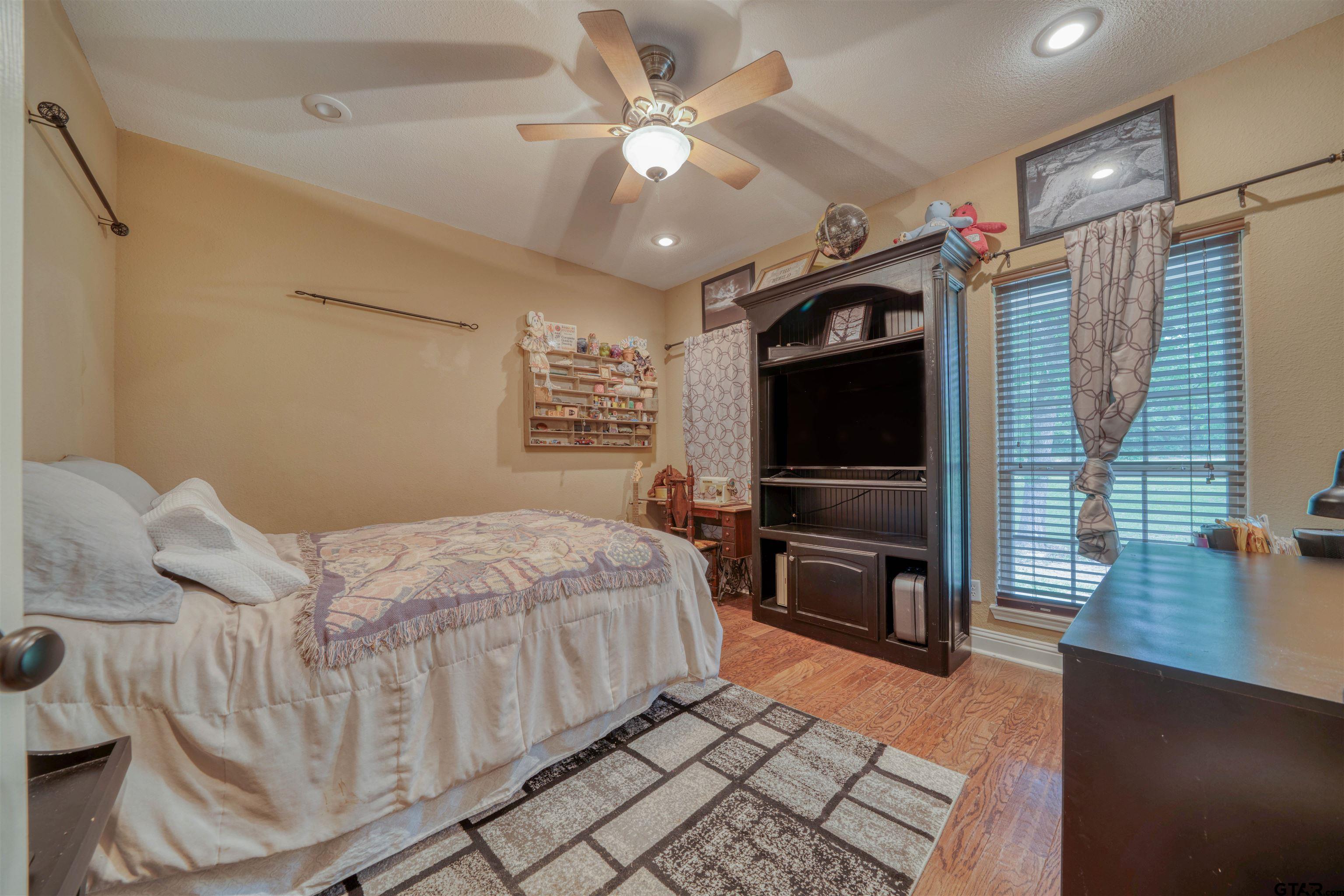 1776 Mustang Road Gilmer, TX 75645 - Photo 29 of 45 a bedroom with furniture and a flat screen tv