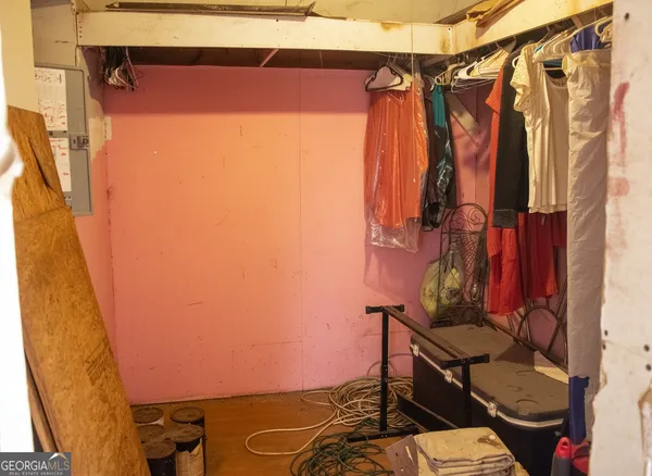 a view of walk in closet with clothes and shoes
