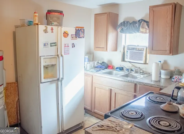 a white refrigerator freezer sitting inside of a kitchen