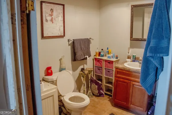 a bathroom with a toilet and a shower curtain