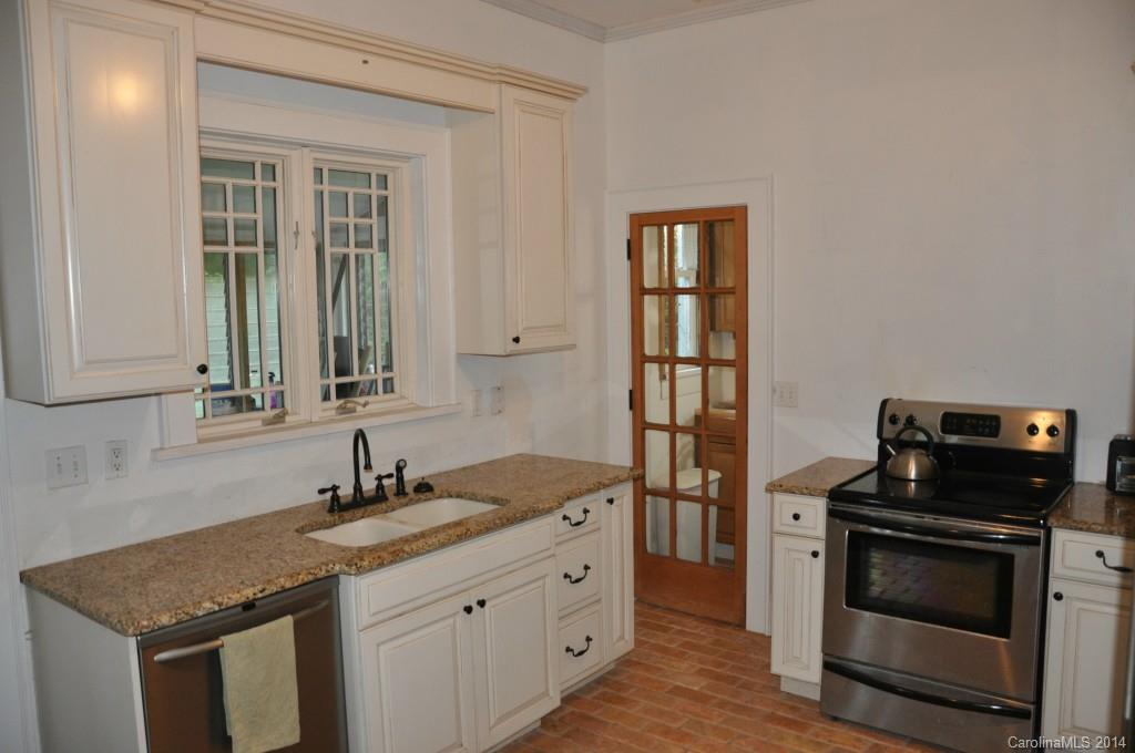 5423 Park Road Charlotte, NC 28209 - Photo 3 of 13 a kitchen with a sink and a stove