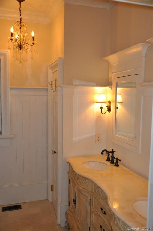 5423 Park Road Charlotte, NC 28209 - Photo 4 of 13 a bathroom with a granite countertop sink a toilet and shower