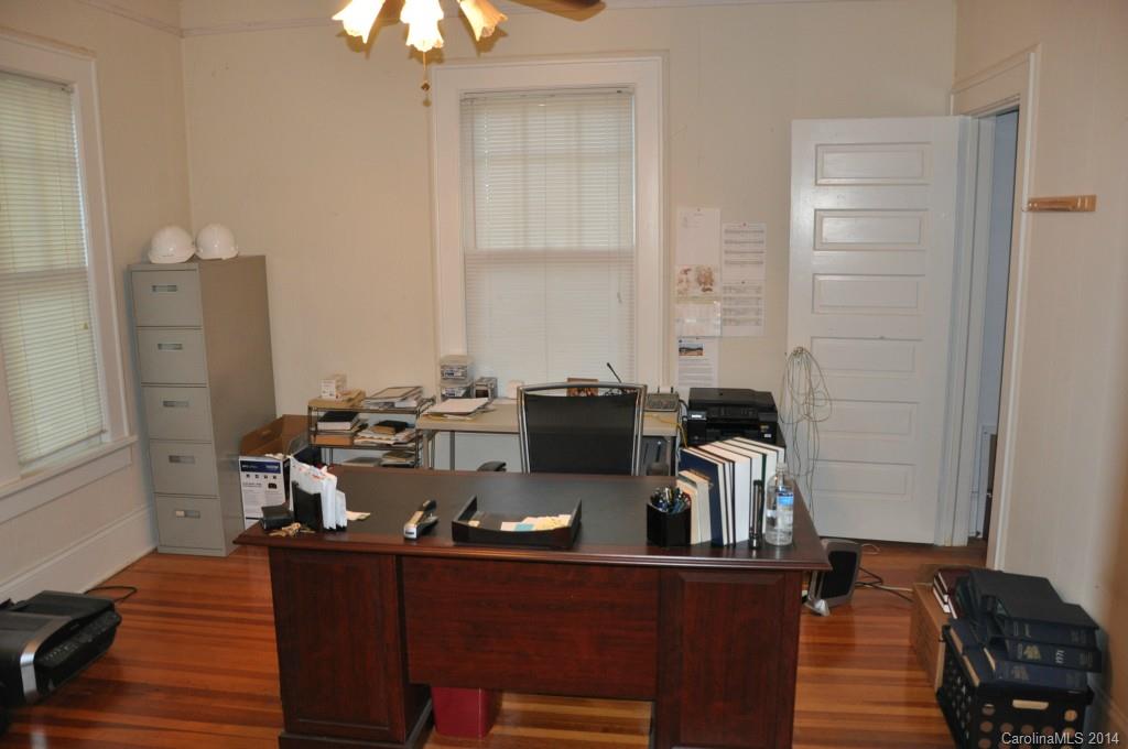 5423 Park Road Charlotte, NC 28209 - Photo 8 of 13 a view of a workspace with furniture and wooden floor