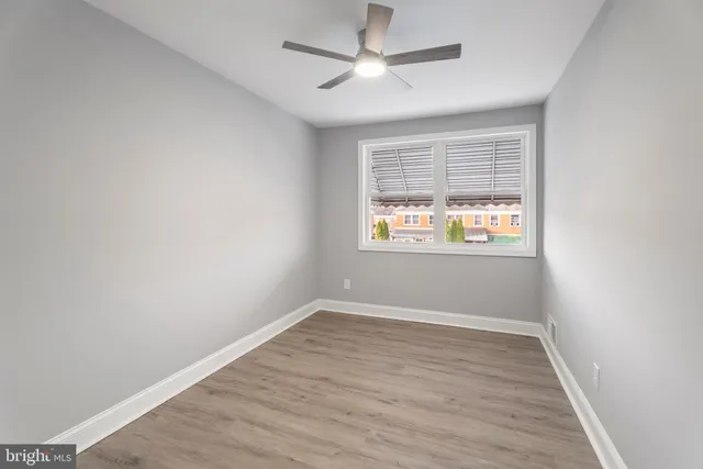 an empty room with wooden floor and closet