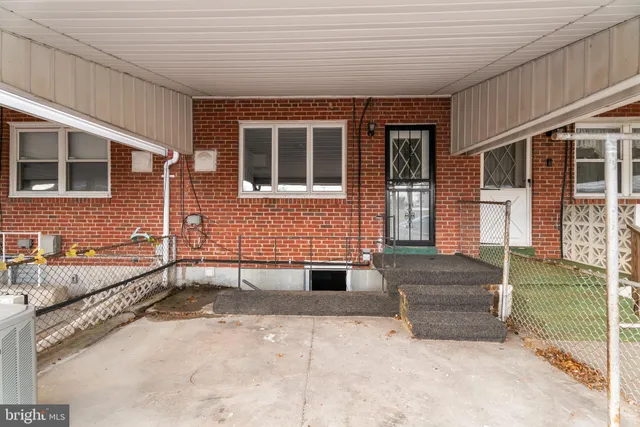 a view of a patio with a table and chairs