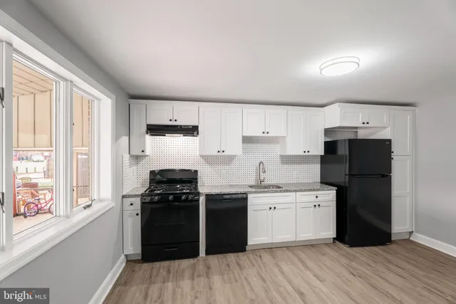 a kitchen with a refrigerator stove and sink