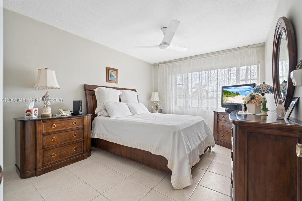 400 South Cypress Road, Unit 424 Pompano Beach, FL 33060 - Photo 15 of 29 a bedroom with a bed and a flat tv screen on dresser