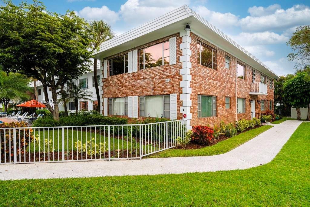 400 South Cypress Road, Unit 424 Pompano Beach, FL 33060 - Photo 18 of 29 a front view of a house with a garden and plants