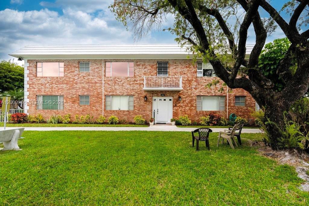 400 South Cypress Road, Unit 424 Pompano Beach, FL 33060 - Photo 22 of 29 a view of a house with backyard sitting area and garden