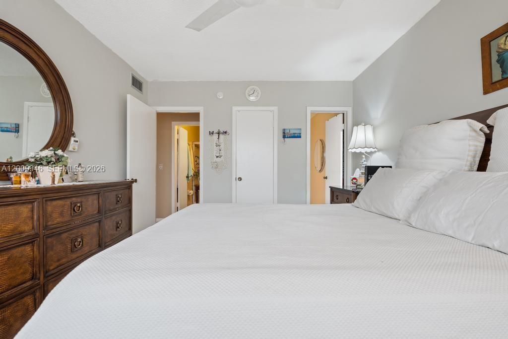 400 South Cypress Road, Unit 424 Pompano Beach, FL 33060 - Photo 23 of 29 a bedroom with a bed and a mirror on dresser
