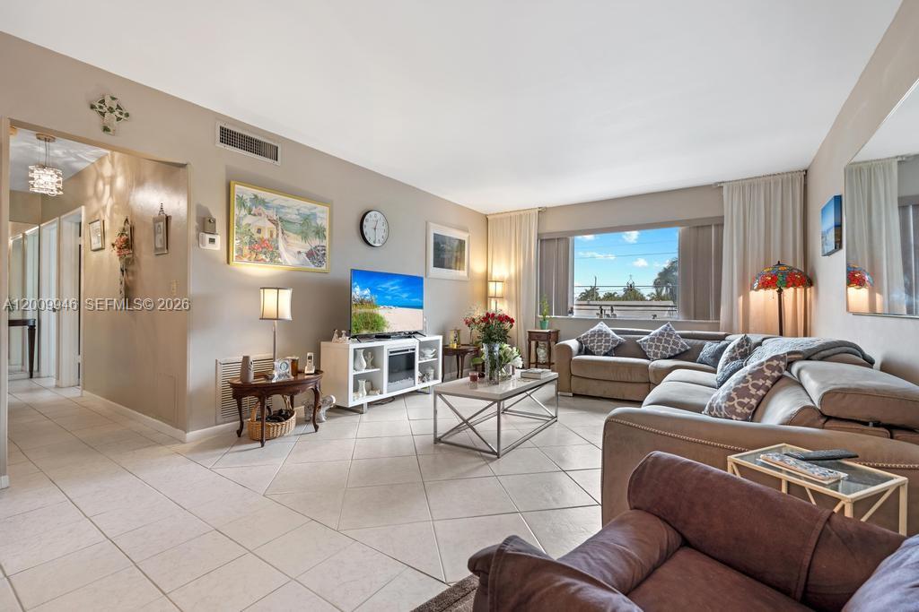 400 South Cypress Road, Unit 424 Pompano Beach, FL 33060 - Photo 5 of 29 a living room with furniture and a large window