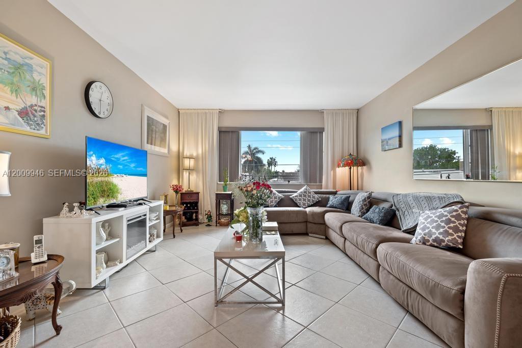 400 South Cypress Road, Unit 424 Pompano Beach, FL 33060 - Photo 6 of 29 a living room with furniture and a flat screen tv