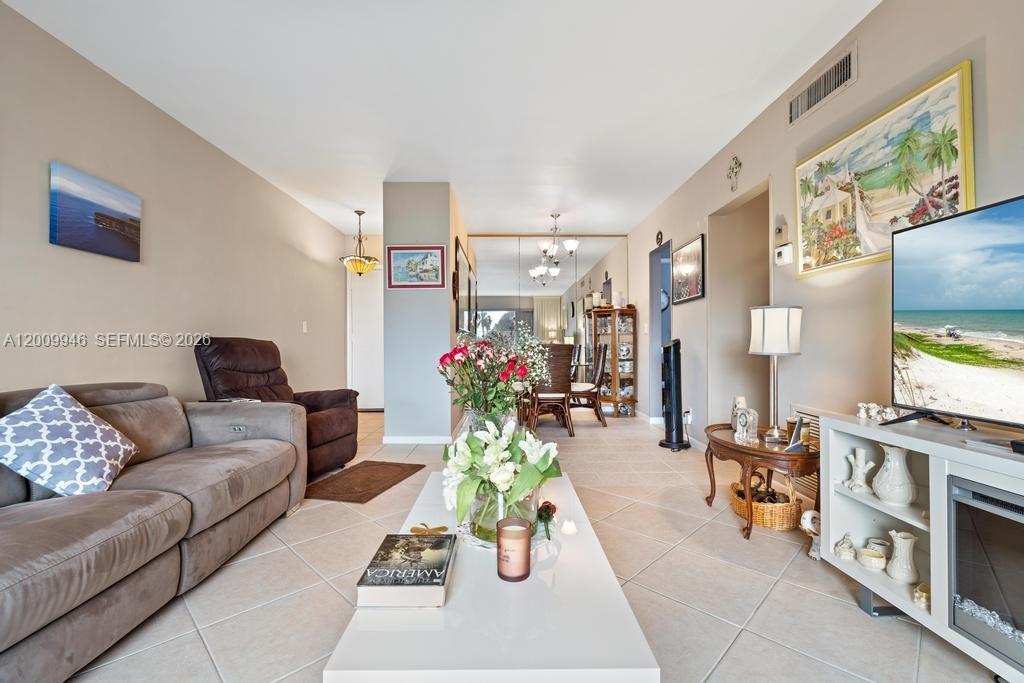 400 South Cypress Road, Unit 424 Pompano Beach, FL 33060 - Photo 7 of 29 a living room with furniture and a flat screen tv