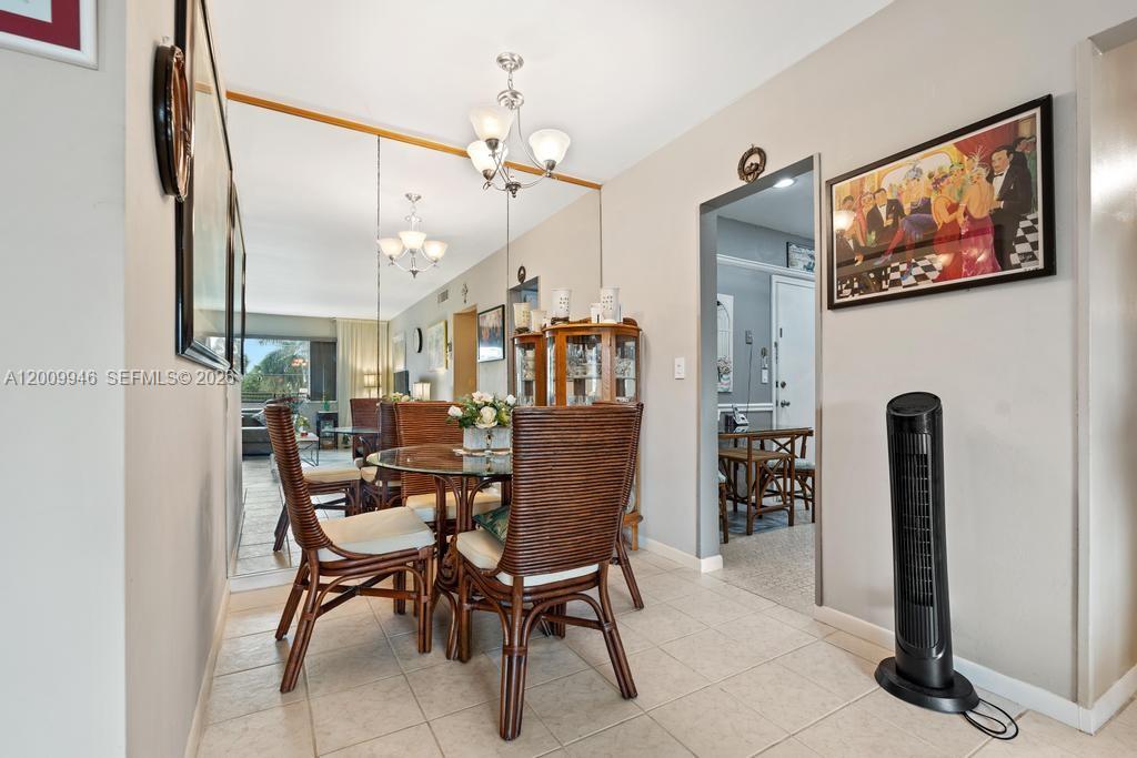 400 South Cypress Road, Unit 424 Pompano Beach, FL 33060 - Photo 9 of 29 a dining room with furniture and a chandelier