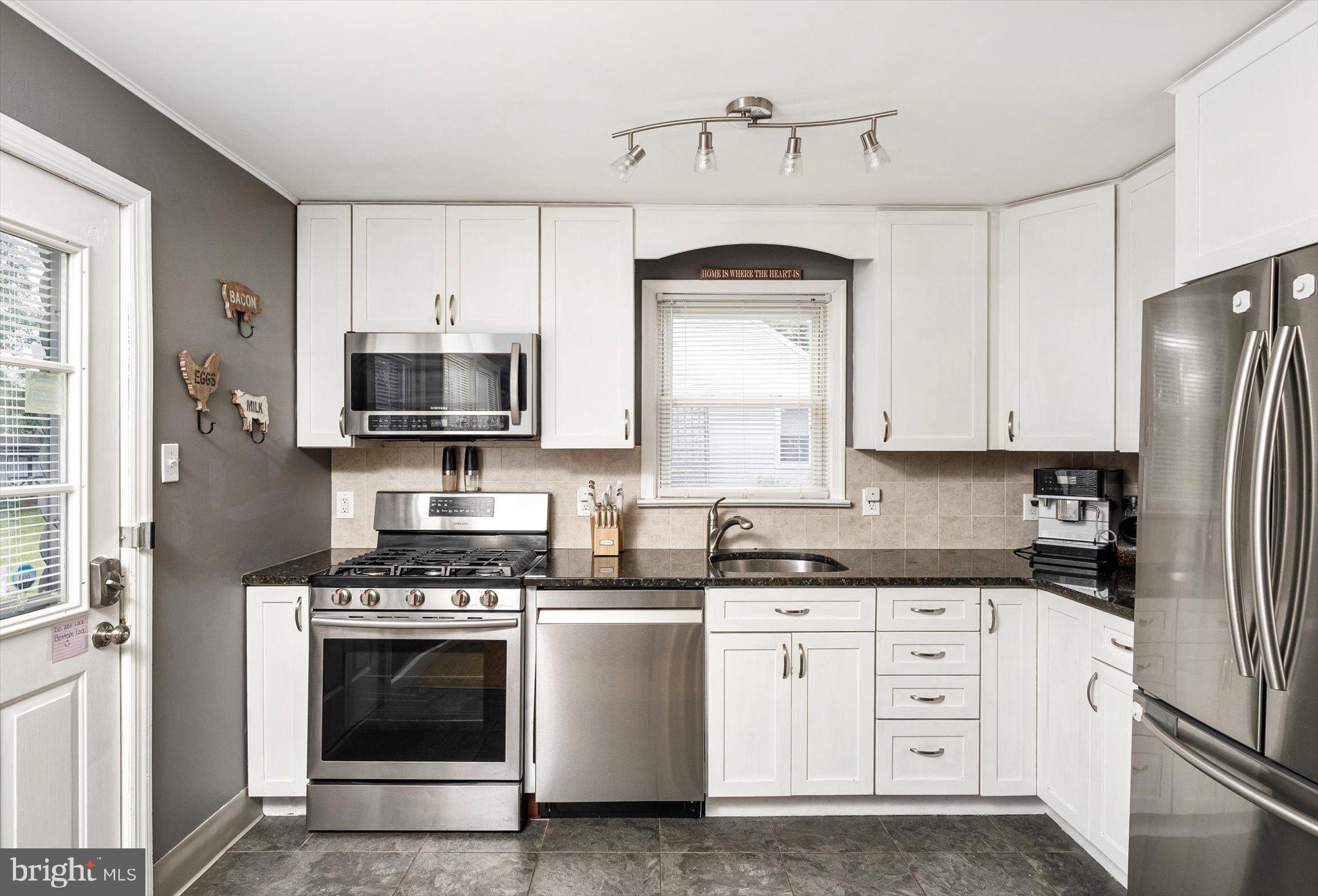 25 Holt Circle Hamilton, NJ 08619 - Photo 12 of 29 a kitchen with stainless steel appliances a stove a sink and a refrigerator