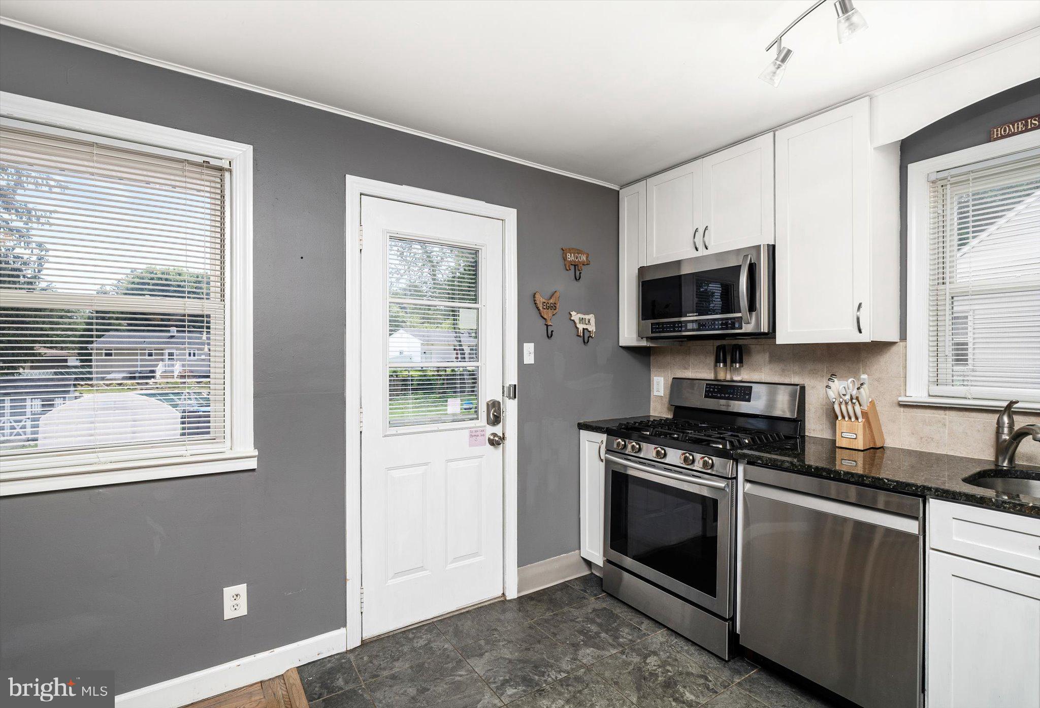25 Holt Circle Hamilton, NJ 08619 - Photo 10 of 29 a kitchen with granite countertop a stove a sink and a microwave