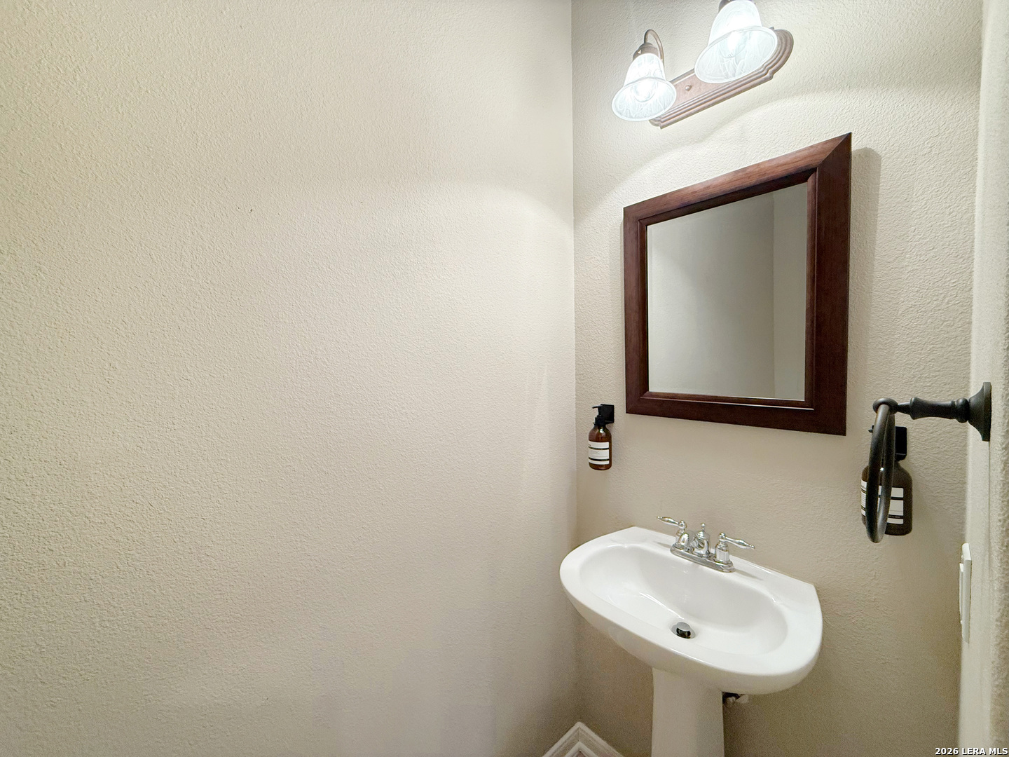 16015 Ponderosa Pth Helotes, TX 78023 - Photo 14 of 49 a bathroom with a sink and a mirror