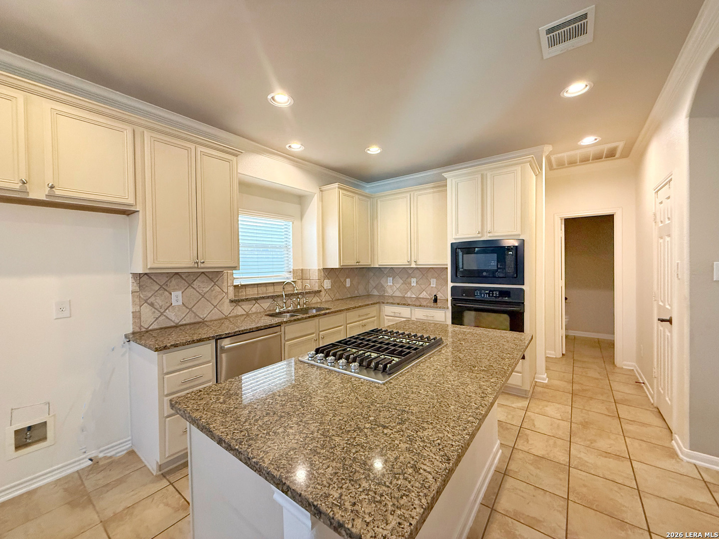 16015 Ponderosa Pth Helotes, TX 78023 - Photo 17 of 49 a kitchen with stainless steel appliances granite countertop a stove sink and cabinets