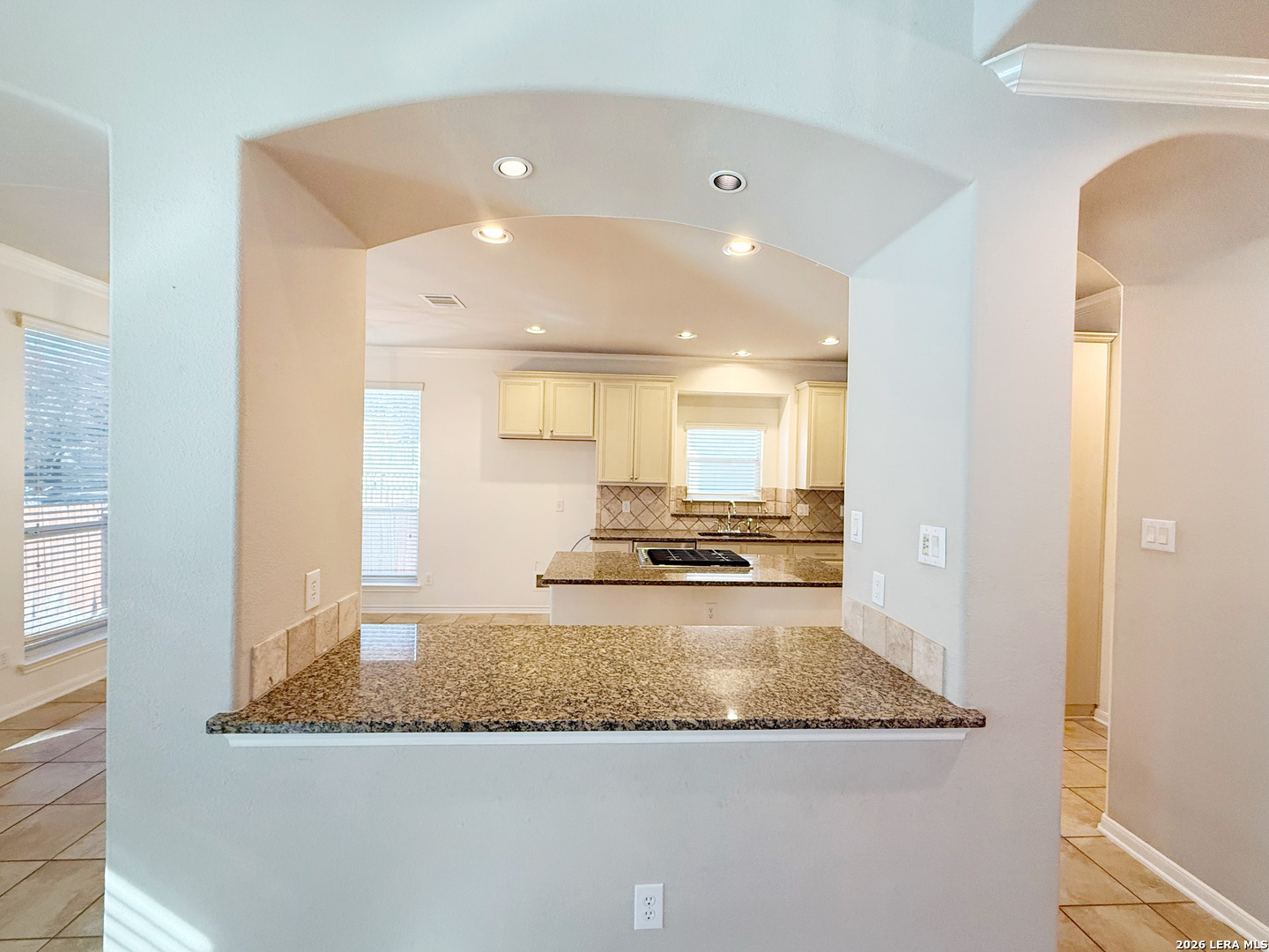 16015 Ponderosa Pth Helotes, TX 78023 - Photo 19 of 49 a view of a kitchen with kitchen island a sink wooden floor and a counter top space