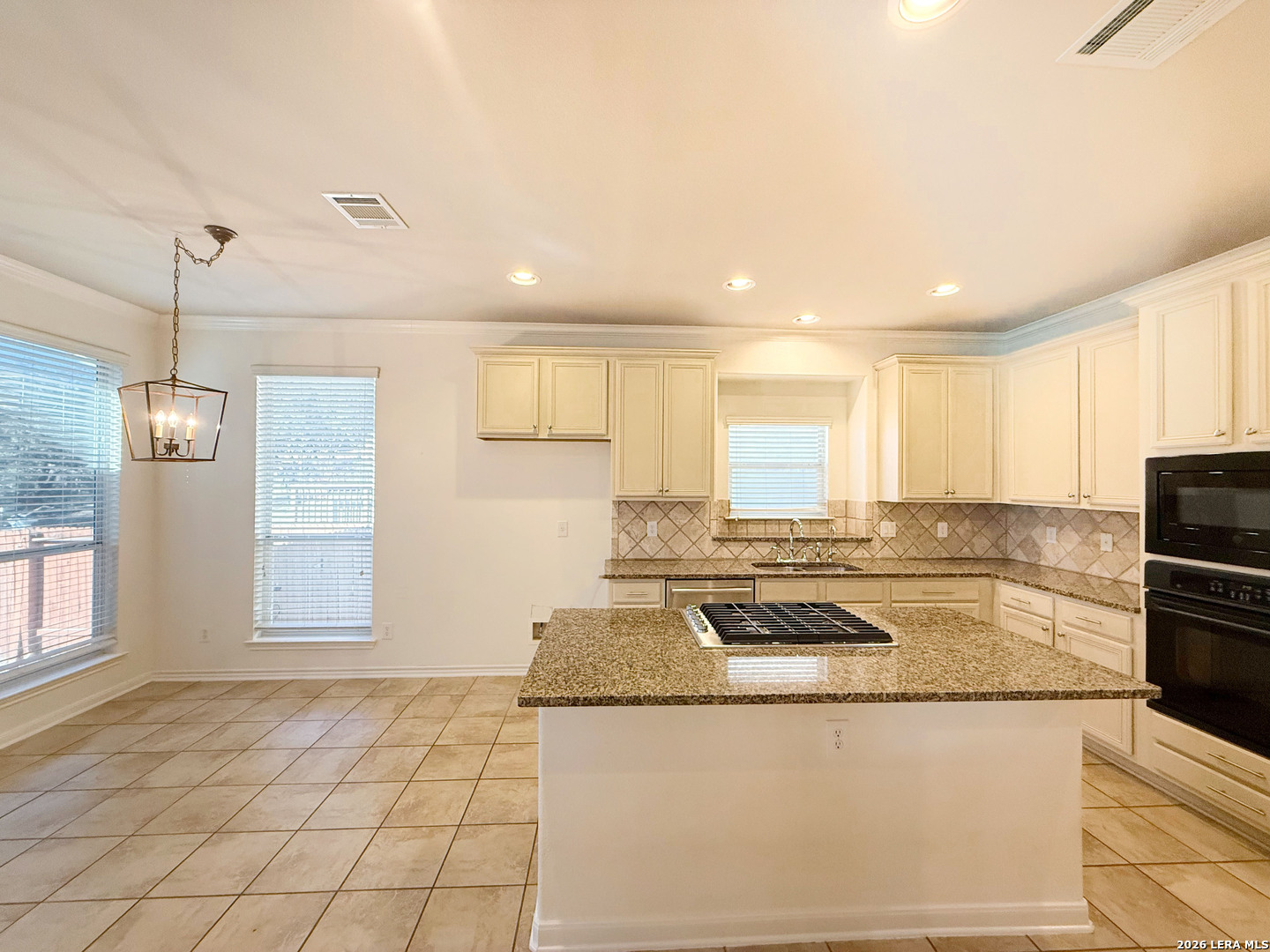16015 Ponderosa Pth Helotes, TX 78023 - Photo 20 of 49 a kitchen with stainless steel appliances granite countertop a stove a sink and a refrigerator
