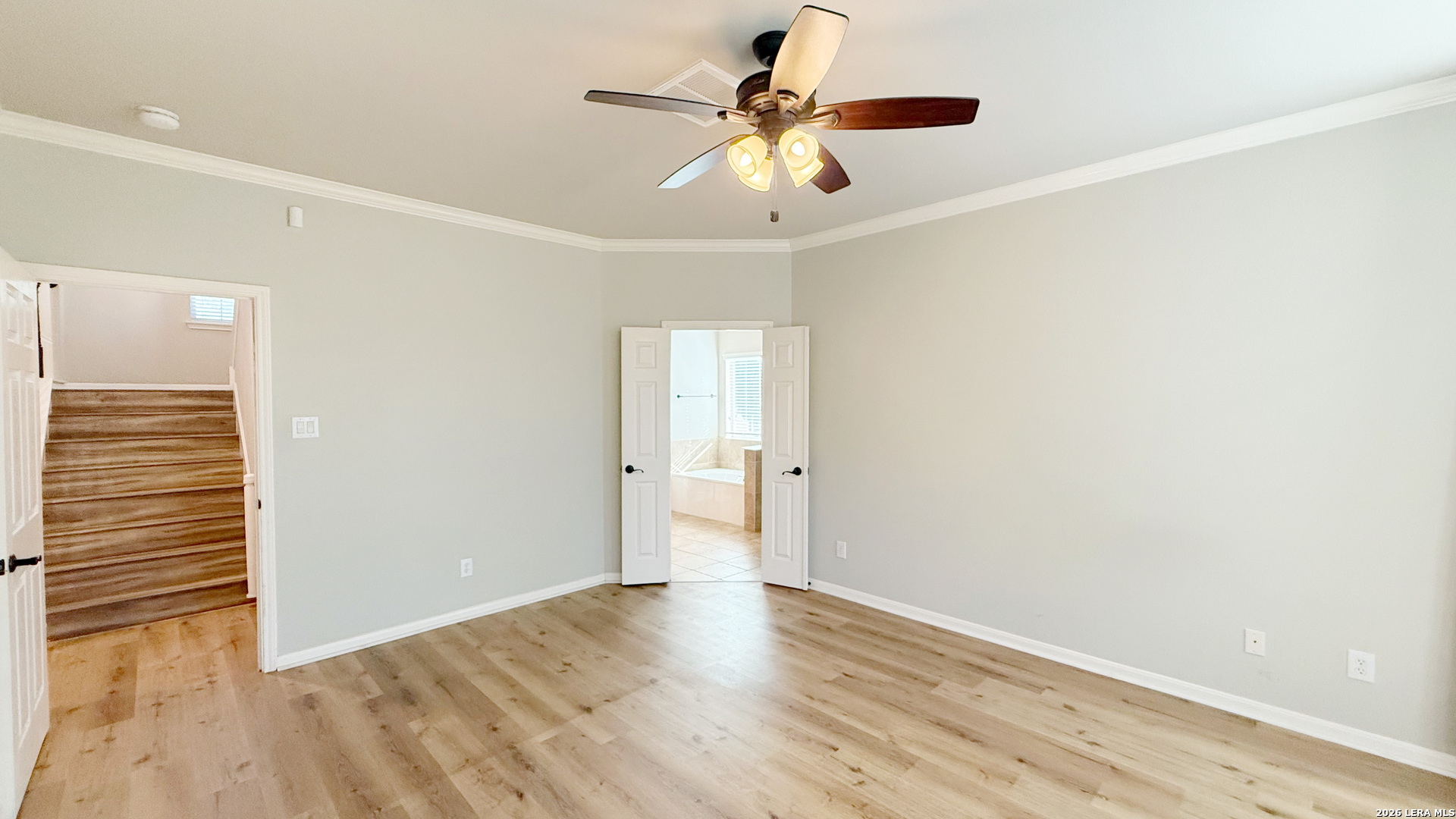 16015 Ponderosa Pth Helotes, TX 78023 - Photo 23 of 49 an empty room with wooden floor chandelier fan and windows