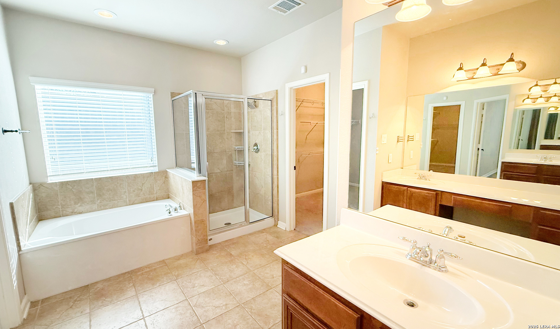 16015 Ponderosa Pth Helotes, TX 78023 - Photo 25 of 49 a spacious bathroom with a tub sink and mirror