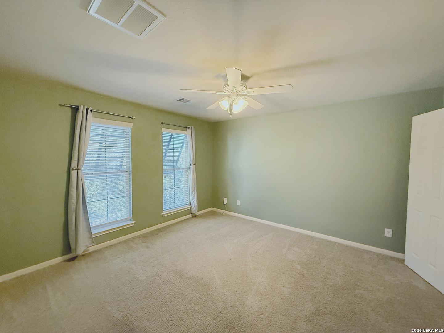 16015 Ponderosa Pth Helotes, TX 78023 - Photo 28 of 49 an empty room with chandelier fan and windows