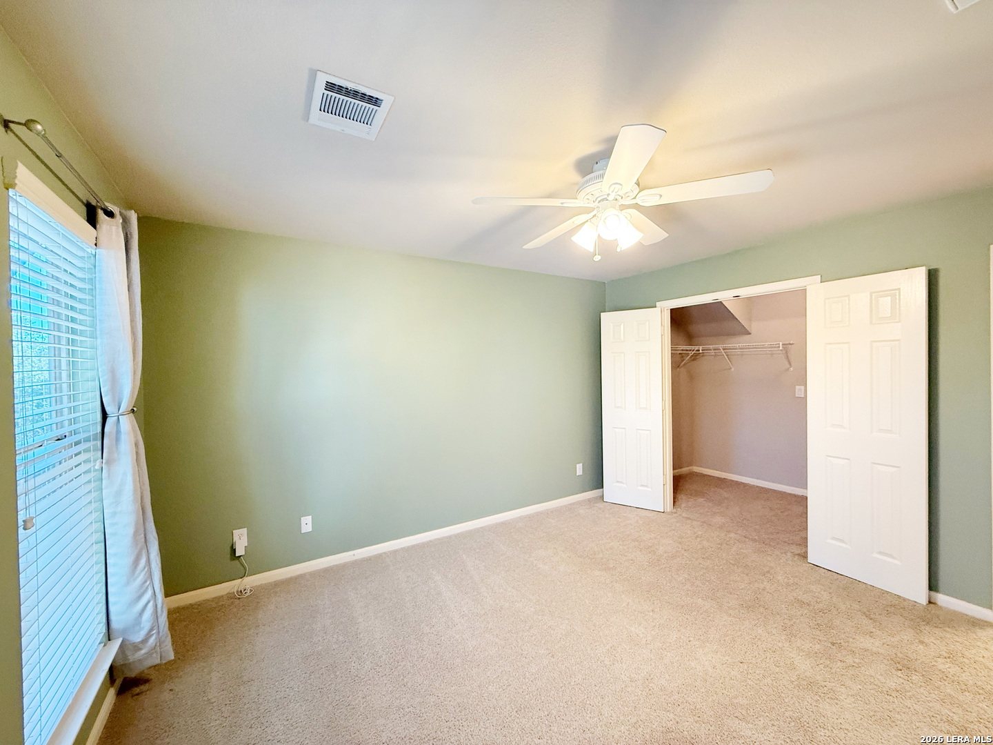 16015 Ponderosa Pth Helotes, TX 78023 - Photo 29 of 49 an empty room with a ceiling fan and a window