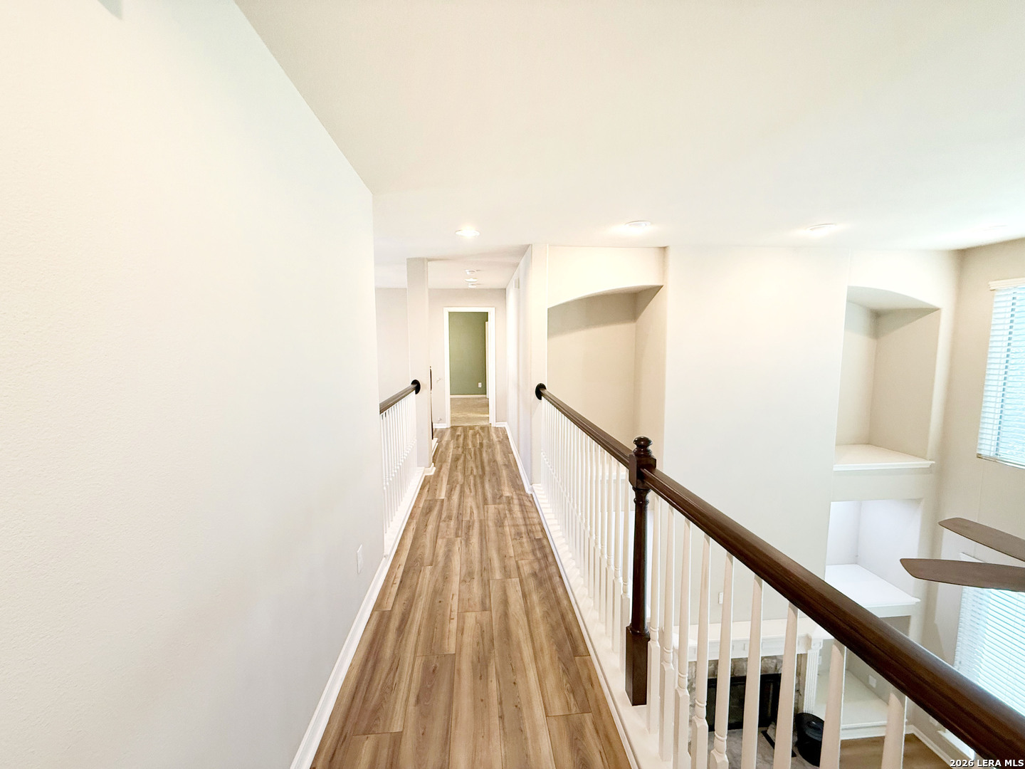 16015 Ponderosa Pth Helotes, TX 78023 - Photo 32 of 49 a view of a hallway with wooden floor and staircase