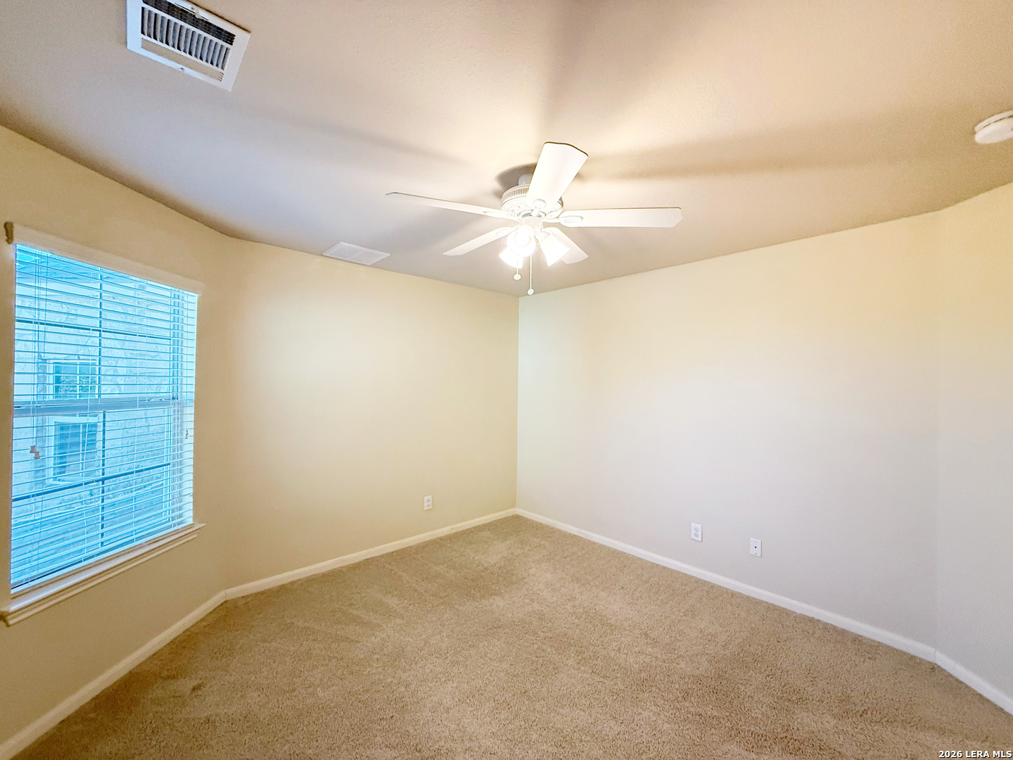 16015 Ponderosa Pth Helotes, TX 78023 - Photo 37 of 49 an empty room with windows and fan
