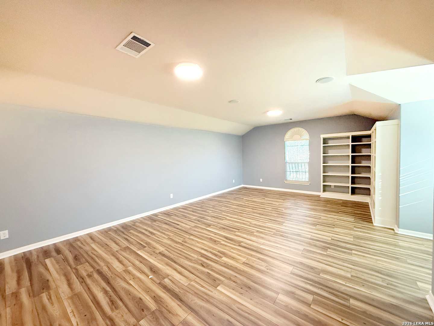 16015 Ponderosa Pth Helotes, TX 78023 - Photo 41 of 49 a view of empty room with wooden floor and fan