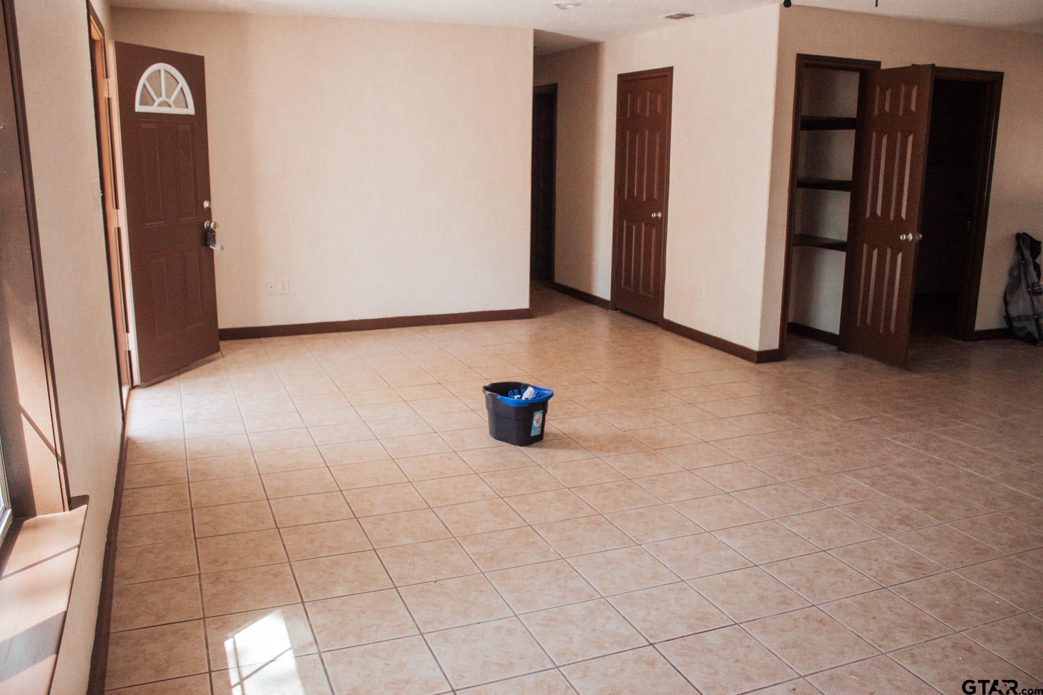 185 Caroline Street Rusk, TX 75785 - Photo 2 of 14 a view of a livingroom with an empty space and a refrigerator
