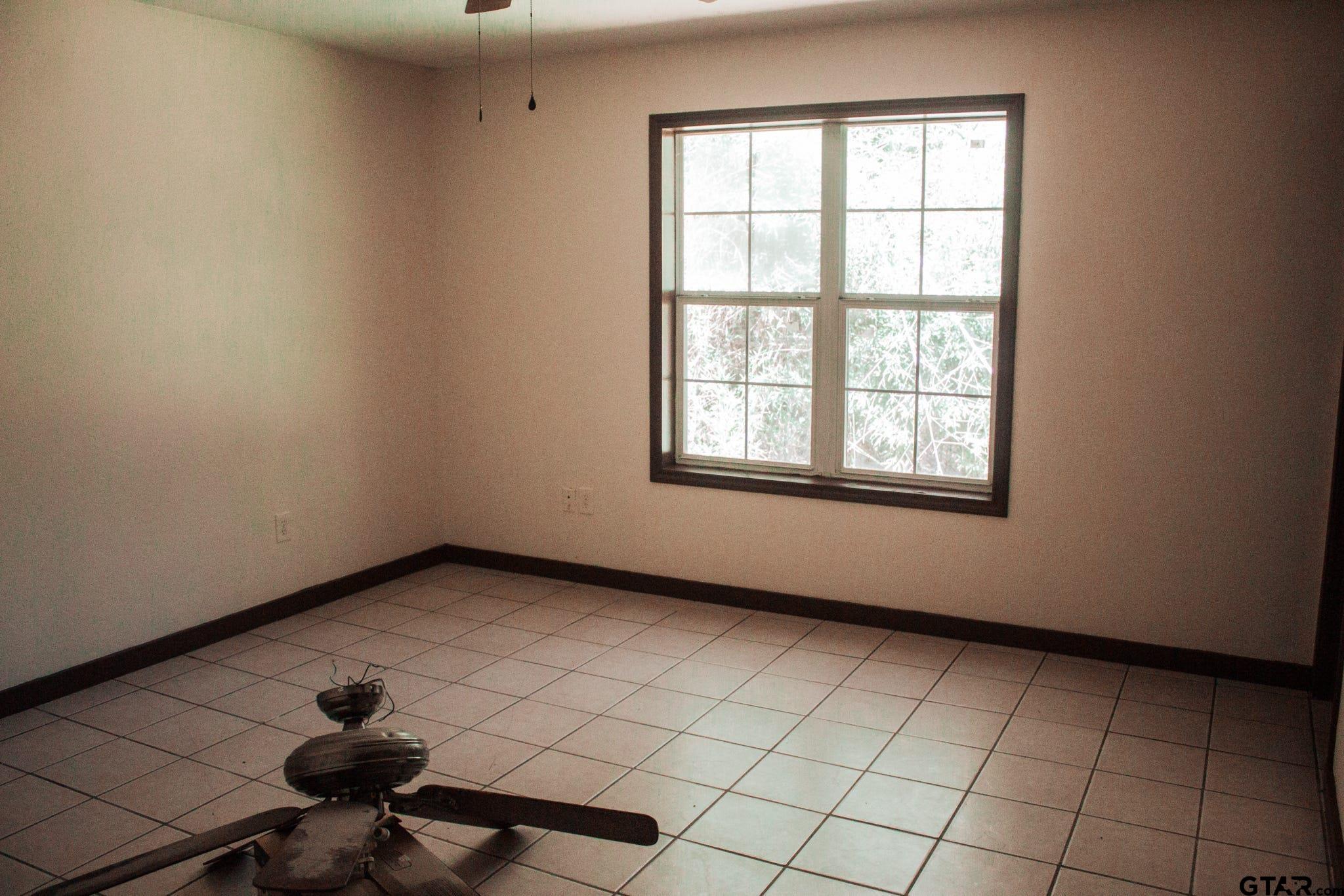 185 Caroline Street Rusk, TX 75785 - Photo 8 of 14 a view of an empty room with a window
